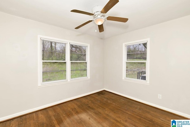 563 Brussels Ave, Birmingham, AL 35212 - unfurnished room with baseboards, dark wood-type flooring, and plenty of natural light
