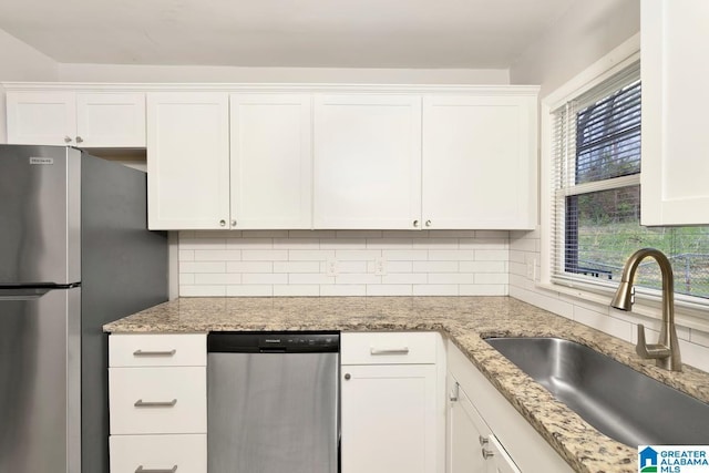 563 Brussels Ave, Birmingham, AL 35212 - kitchen featuring a sink, backsplash, appliances with stainless steel finishes, and white cabinets