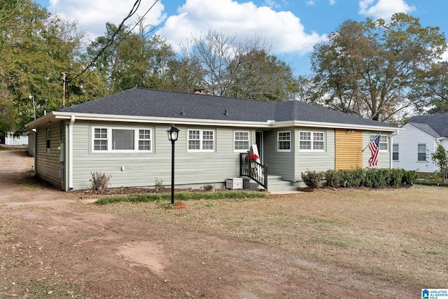 view of front facade with roof with shingles