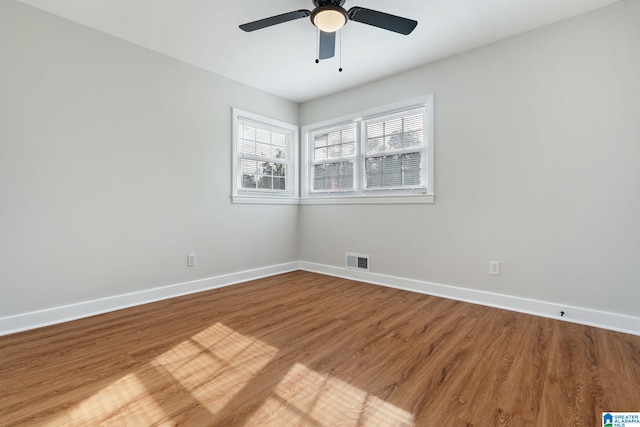 spare room with ceiling fan, baseboards, visible vents, and light wood-type flooring