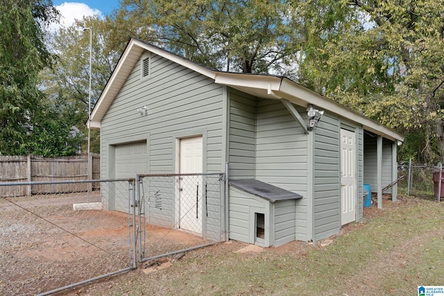 view of outdoor structure with a gate, an outdoor structure, and fence