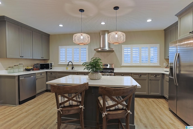 2365 Jim Raney Ln, Bessemer, AL 35023 - kitchen with a sink, wall chimney range hood, appliances with stainless steel finishes, light wood-type flooring, and gray cabinets
