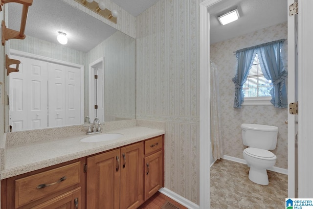2350 Morton Rd, Warrior, AL 35180 - bathroom with wallpapered walls, baseboards, toilet, vanity, and a textured ceiling