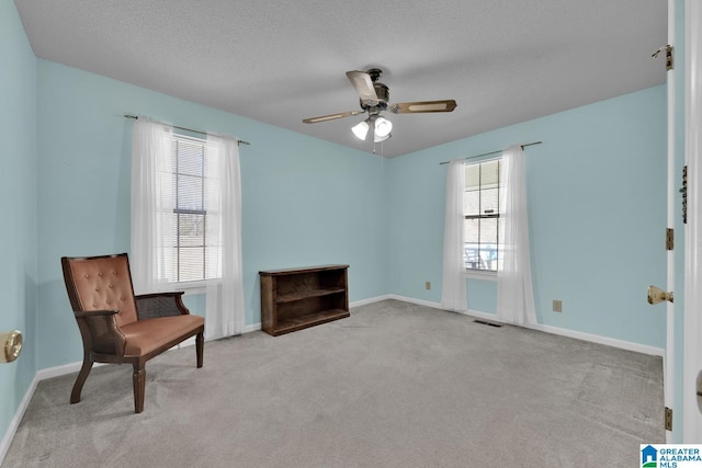 2350 Morton Rd, Warrior, AL 35180 - sitting room featuring a ceiling fan, baseboards, visible vents, a textured ceiling, and carpet flooring