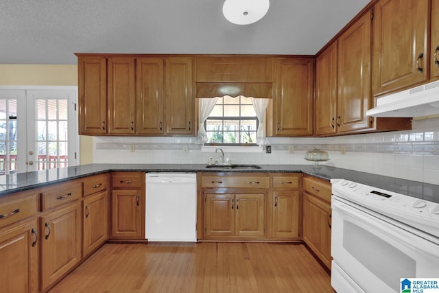 2350 Morton Rd, Warrior, AL 35180 - kitchen with under cabinet range hood, brown cabinets, white appliances, and a sink