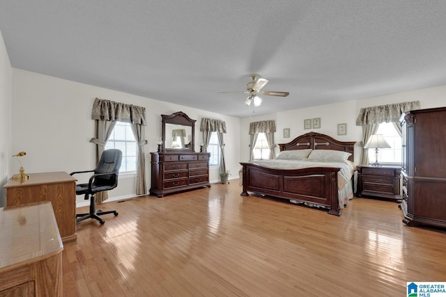 2350 Morton Rd, Warrior, AL 35180 - bedroom with ceiling fan, a textured ceiling, light wood-type flooring, and baseboards