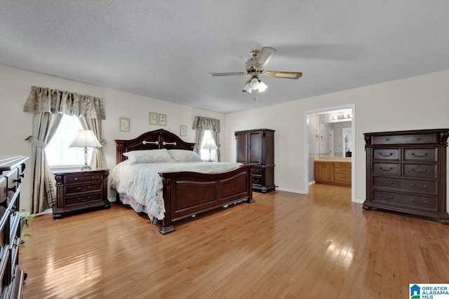 2350 Morton Rd, Warrior, AL 35180 - bedroom featuring a ceiling fan, baseboards, light wood finished floors, a textured ceiling, and connected bathroom
