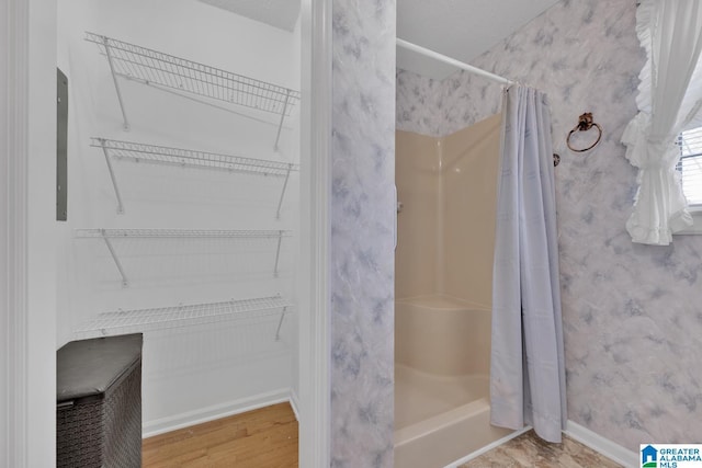2350 Morton Rd, Warrior, AL 35180 - full bathroom featuring a shower stall, wallpapered walls, a walk in closet, and baseboards