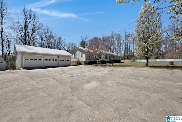 2350 Morton Rd, Warrior, AL 35180 - view of front facade featuring a garage, metal roof, and an outdoor structure