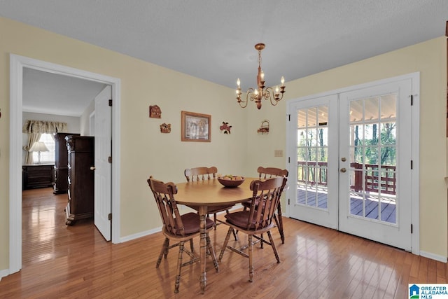 2350 Morton Rd, Warrior, AL 35180 - dining area with french doors, baseboards, a chandelier, and light wood finished floors