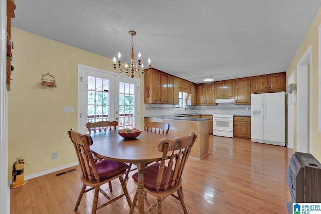 2350 Morton Rd, Warrior, AL 35180 - dining space featuring visible vents, an inviting chandelier, baseboards, and light wood-style floors