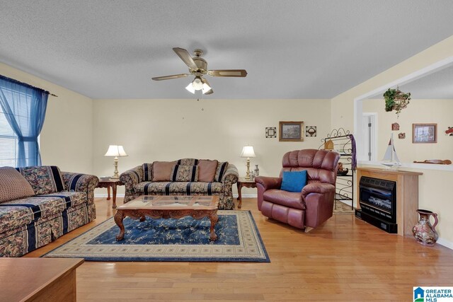 2350 Morton Rd, Warrior, AL 35180 - living room featuring a textured ceiling, ceiling fan, and wood finished floors