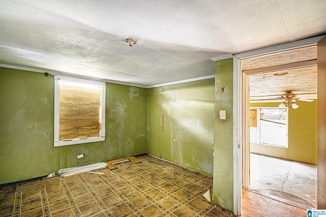 unfurnished room featuring ceiling fan, tile patterned floors, and a textured ceiling