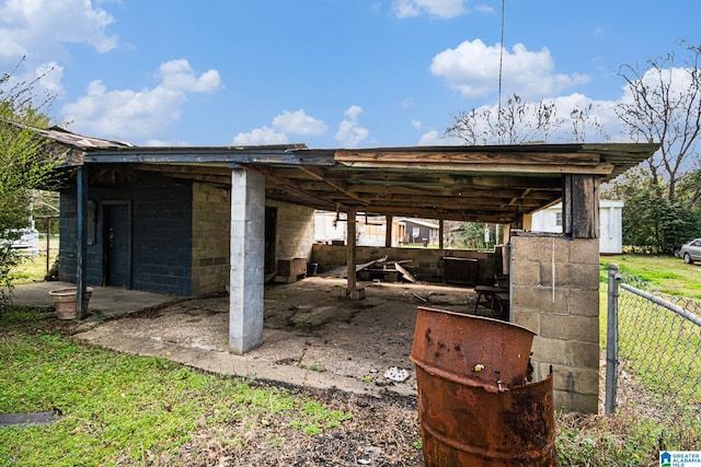 exterior space featuring an attached carport and fence