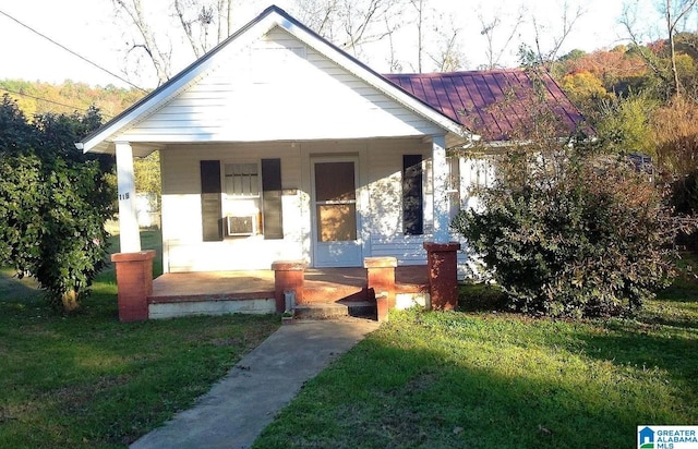 bungalow-style home featuring a porch and a front yard
