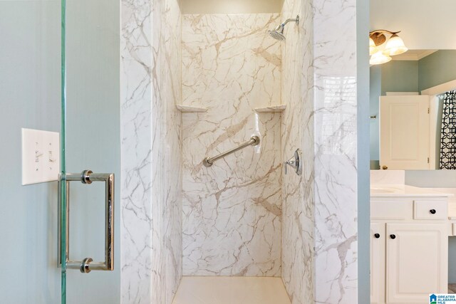 full bath with vanity and a marble finish shower