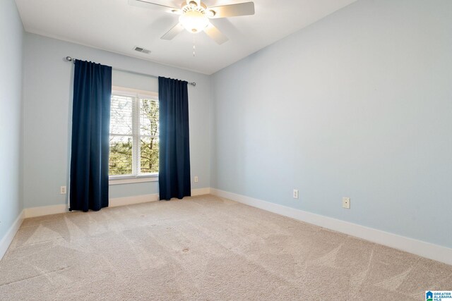 carpeted empty room featuring visible vents, baseboards, and a ceiling fan