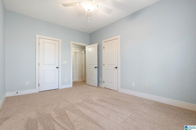 unfurnished bedroom featuring carpet, baseboards, and ceiling fan