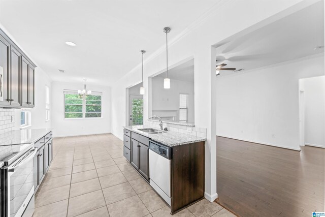 kitchen featuring electric stove, light stone counters, ceiling fan with notable chandelier, dishwasher, and a sink