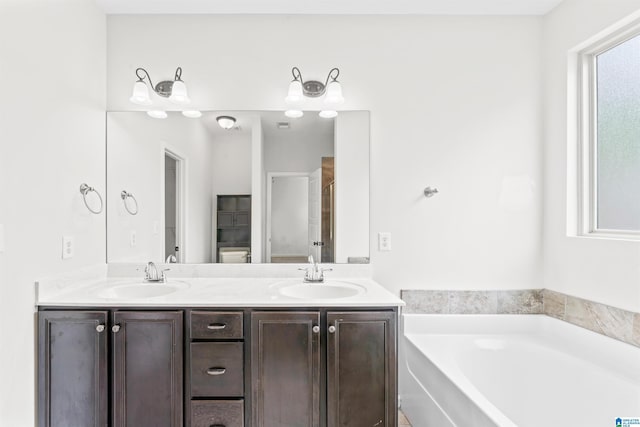 full bathroom with double vanity, an enclosed shower, a bath, and a sink