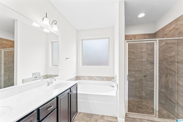 bathroom with a sink, a stall shower, double vanity, and a bath