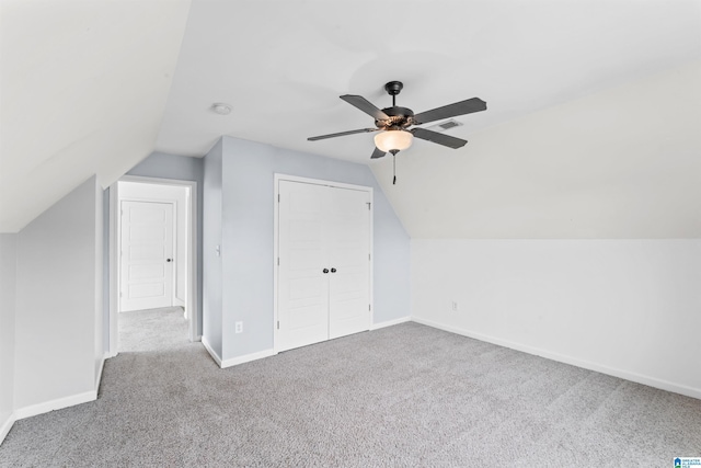 additional living space featuring carpet, ceiling fan, baseboards, visible vents, and lofted ceiling