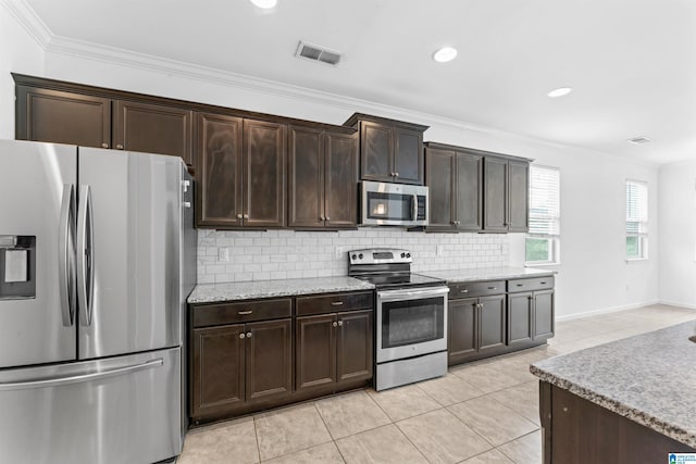 kitchen with decorative backsplash, light tile patterned floors, appliances with stainless steel finishes, dark brown cabinets, and visible vents