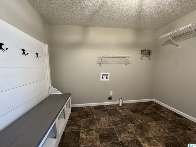 laundry room featuring electric dryer hookup, baseboards, hookup for a washing machine, and laundry area