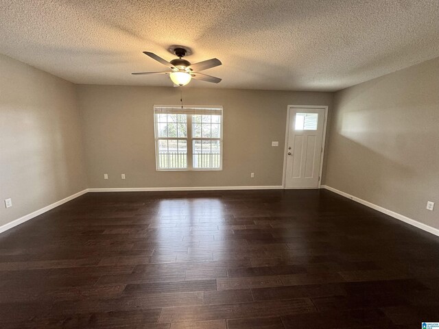 interior space with a healthy amount of sunlight, baseboards, dark wood-type flooring, and ceiling fan