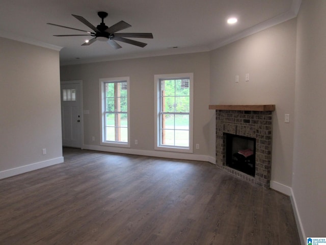 unfurnished living room with wood finished floors, baseboards, ornamental molding, and a fireplace