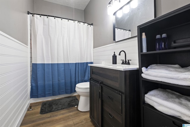 1109 Central Ave, Gadsden, AL 35904 - full bathroom with a wainscoted wall, toilet, a shower with shower curtain, wood finished floors, and vanity