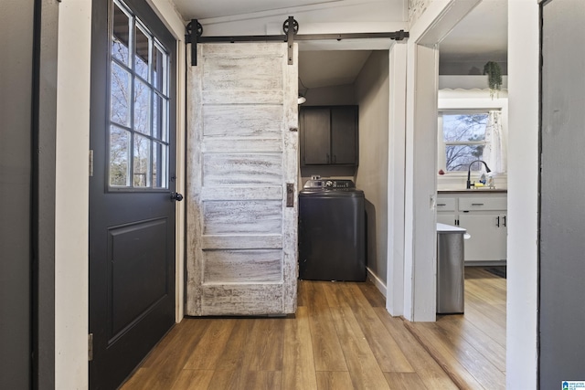 1109 Central Ave, Gadsden, AL 35904 - washroom with wood finished floors, a wealth of natural light, washer / clothes dryer, and cabinet space