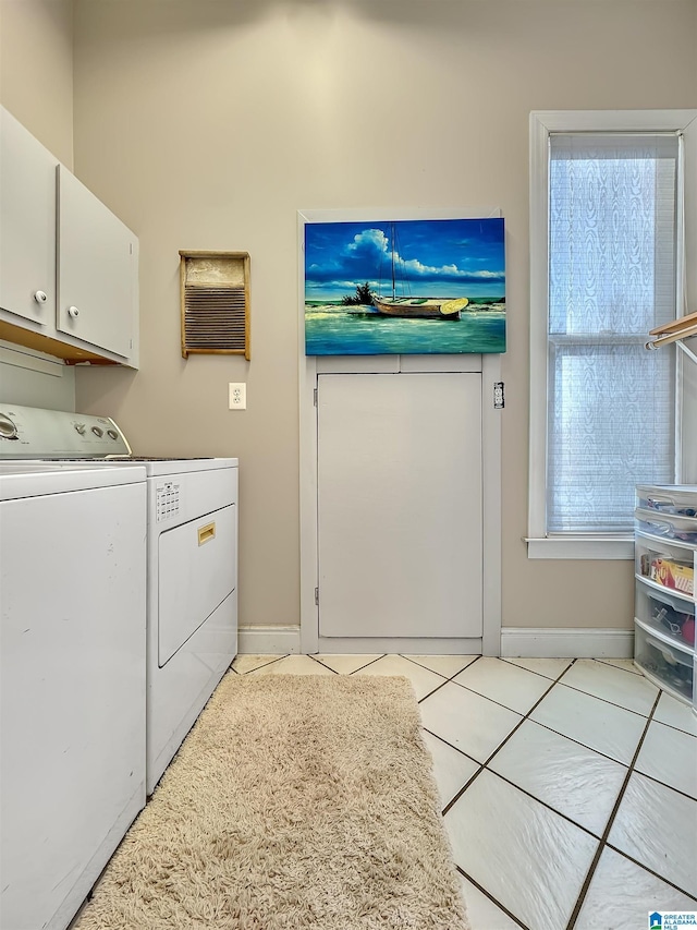 385 Rouse Rd, Sumiton, AL 35148 - clothes washing area with cabinet space, light tile patterned floors, washing machine and dryer, and baseboards