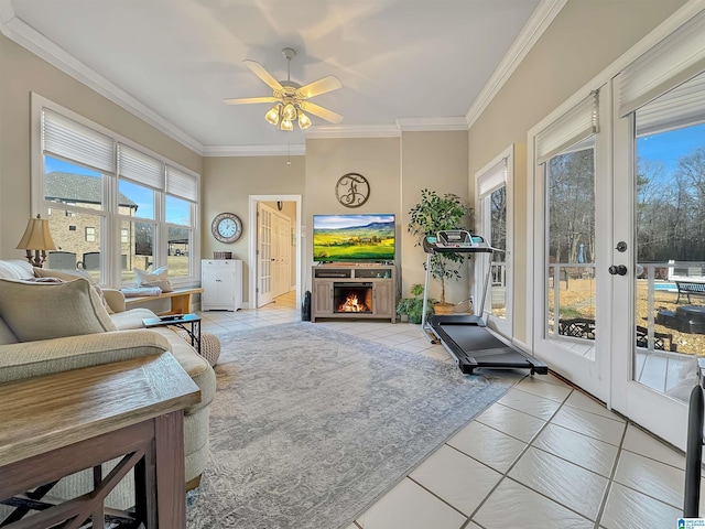 385 Rouse Rd, Sumiton, AL 35148 - living room featuring a lit fireplace, light tile patterned floors, ceiling fan, and ornamental molding