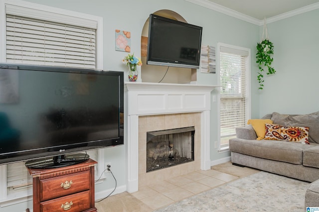 living room with light tile patterned floors, a tile fireplace, crown molding, and a healthy amount of sunlight