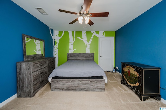 carpeted bedroom featuring visible vents, baseboards, and a ceiling fan