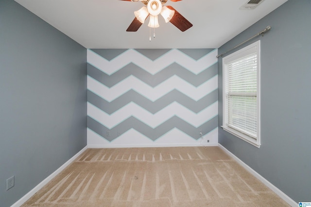 spare room featuring visible vents, ceiling fan, carpet, and baseboards
