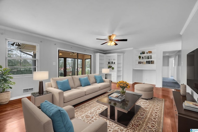 817 Milgray Ln, Bessemer, AL 35022 - living area with visible vents, ceiling fan, built in features, ornamental molding, and wood finished floors