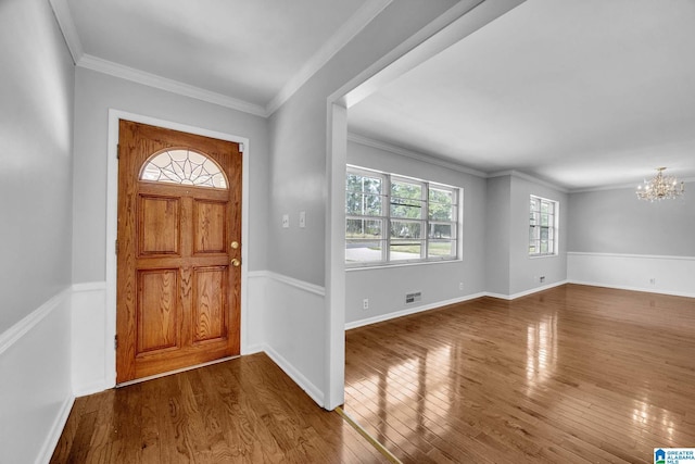 817 Milgray Ln, Bessemer, AL 35022 - entryway featuring wood finished floors, baseboards, visible vents, crown molding, and a chandelier