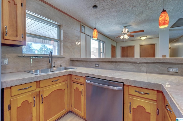 kitchen with a sink, dishwasher, a ceiling fan, and a healthy amount of sunlight