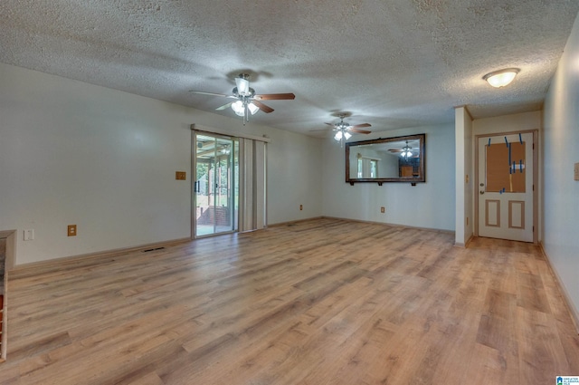 unfurnished living room with ceiling fan, baseboards, a textured ceiling, and light wood-style flooring