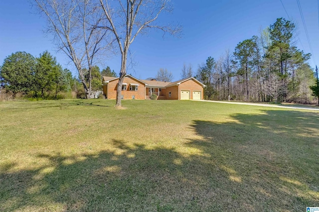 view of front of house with an attached garage and a front lawn