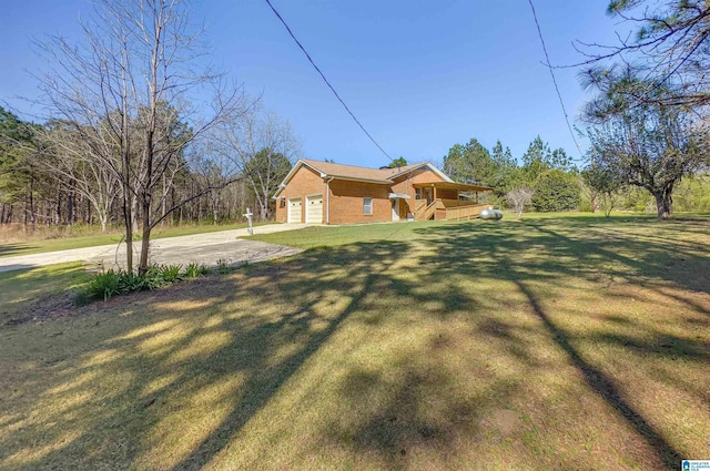 exterior space with concrete driveway, a lawn, and a garage