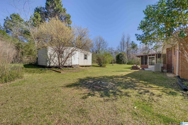 view of yard featuring an outbuilding, cooling unit, entry steps, and a sunroom