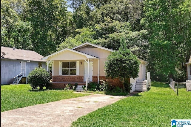 63 Bluebell St, Bessemer, AL 35020 - view of front of property featuring brick siding, a front yard, and fence