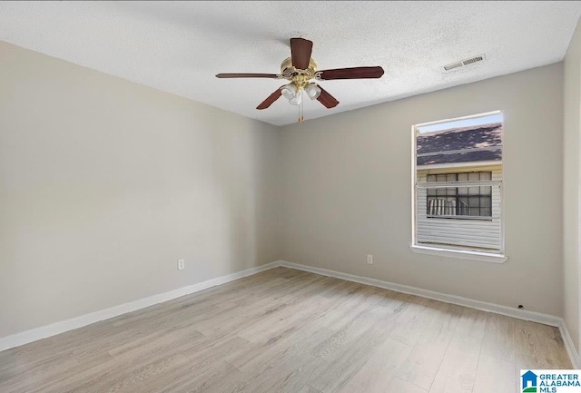 63 Bluebell St, Bessemer, AL 35020 - unfurnished room featuring visible vents, baseboards, a textured ceiling, and light wood finished floors