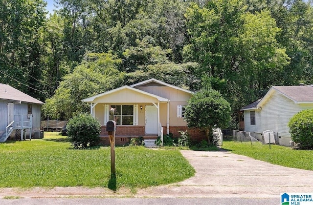 63 Bluebell St, Bessemer, AL 35020 - bungalow-style home with brick siding, fence, a porch, a front yard, and central AC unit
