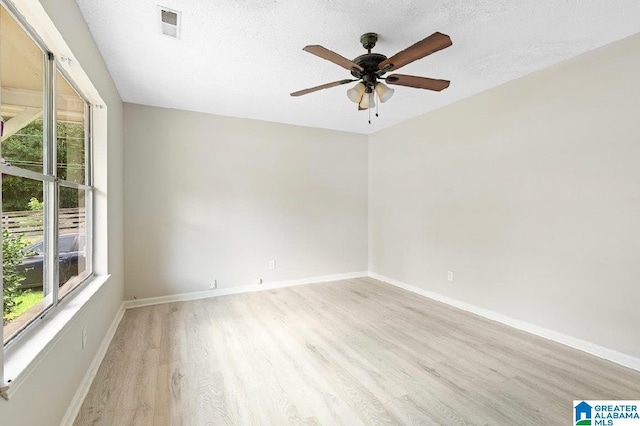 63 Bluebell St, Bessemer, AL 35020 - empty room featuring light wood-type flooring, plenty of natural light, baseboards, and ceiling fan