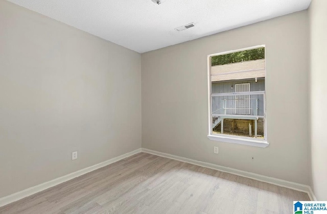 63 Bluebell St, Bessemer, AL 35020 - unfurnished room featuring visible vents, baseboards, a textured ceiling, and wood finished floors
