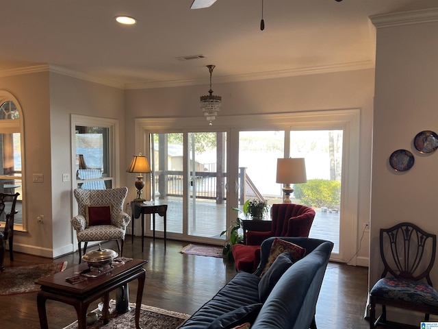 living room with visible vents, ornamental molding, a ceiling fan, dark wood finished floors, and baseboards
